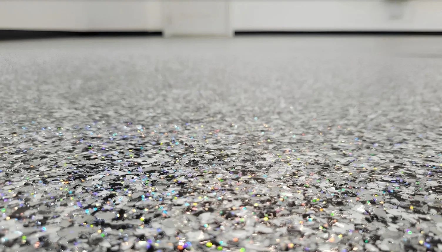 Close-up of a sparkling gray and black flake epoxy floor